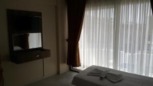 A bed or beds in a room at Ozgun Apart Hotel
