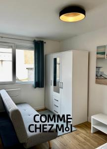 a living room with a couch and a cabinet at Studio Le Petit Placieux, Garage Gratuit sur place in Nancy +2 photos