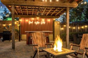 a patio with a table and a fire pit at Spectacular Suites Sleep 20 Near Fq W Pool in New Orleans