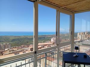 a view of the ocean from a room with windows at Temples and Sea view Apartment in Agrigento