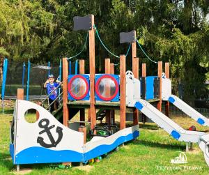 a child on a pirate ship playground at Przystań Piława in Borne Sulinowo