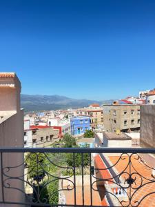 a view of a city from a balcony at Perla Azul Penthouse in Chefchaouene +3 photos