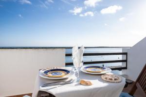 a table with plates of food on top of a balcony at NEW !! Studio Ria Formosa - Cabanas de Tavira in Cabanas de Tavira