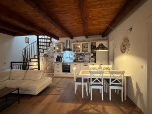 a kitchen and living room with a table and chairs at Vila More moje A2 in Vis