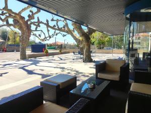 a view of a patio with chairs and trees at Hotel Miramar Playa America Nigran in Nigrán