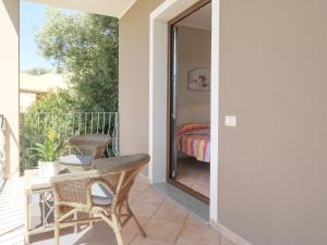 a patio with a table and chairs on a balcony at B&B I Colori di Chia in Chia +12 photos