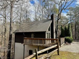 a small house with a porch and a garage at Mystical Haven Honeymoon Cabin in Sevierville