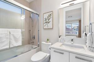 a bathroom with a toilet and a sink and a shower at Centrally Located Luxury Home with Views and Cinema in Vancouver +54 photos