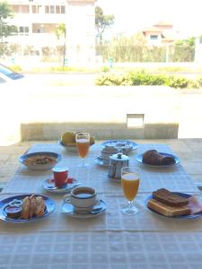 a blue table with breakfast foods and drinks on it at Hotel Miramar Playa America Nigran in Nigrán