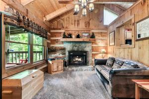a living room with a couch and a fireplace at Blissful Bear Heaven- Honeymoon Cabin in Sevierville