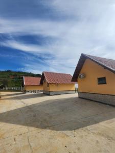 two buildings with red roofs in a parking lot at Hotel Porto dos Milagres in Aparecida +222 photos