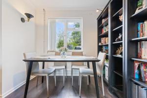 a dining room with a table and chairs and a window at 3Bed 2Bath nr Uni HertsHatfield in North Mimms