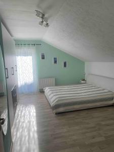 a bedroom with a large bed and a window at Ferienwohnung Alpenblick in Wasserburg am Inn