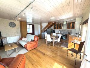 a living room with a couch and a table at La Grange de Montrésor in Montrésor