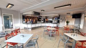 a restaurant with tables and chairs and a kitchen at Hotel Miramar Playa America Nigran in Nigrán +37 photos