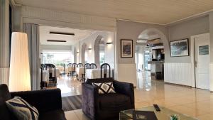a living room with a table and chairs at Hotel Miramar Playa America Nigran in Nigrán