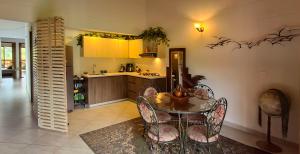 a kitchen with a table and chairs and a kitchen with yellow cabinets at La Casa Del Sol in Jardin +29 photos