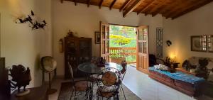 a living room with a glass table and chairs at La Casa Del Sol in Jardin +28 photos