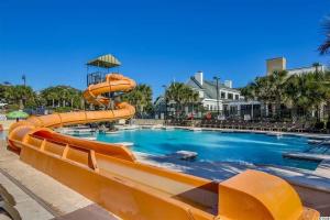 a large swimming pool with an orange water slide at Luxury 2br 2 ba beachfront condo in Myrtle Beach