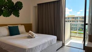 a hotel room with a bed and a large window at Makia Beach Experience Muro Alto Porto de Galinhas in Ipojuca +106 photos