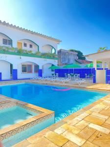 a swimming pool in front of a house at Colonia SINTIPACESP in Praia Grande