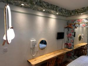 a bathroom with a mirror and a phone on the wall at Rest Boutique Portobello in London