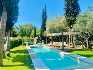 a swimming pool in a garden with a gazebo at La Limonaia della Torretta Luxury Private Pool in Florence