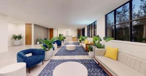 a lobby with couches and chairs and potted plants at Park Royal Orlando in Kissimmee