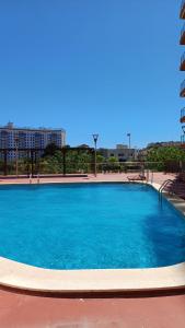 a large blue swimming pool with buildings in the background at ANIMAR piso en ALGAIDA Oropesa in Oropesa del Mar