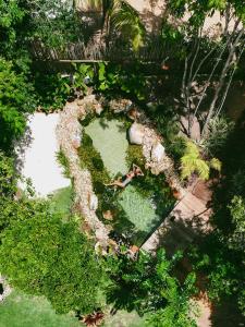 an overhead view of a person in a pool of water at Boa Village- Bungalow com Piscina Natural- Praia de Algodões in Marau