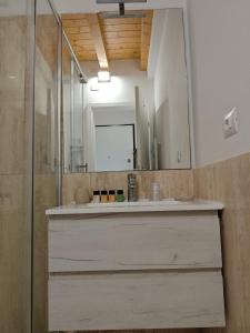 a bathroom with a sink and a mirror at Flamingo View apartment in Orbetello +33 photos