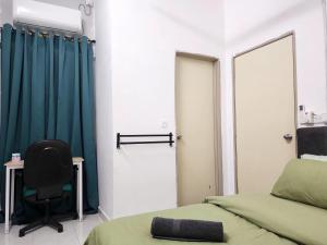 a room with two beds and a chair and a mirror at Dirgahayu Homestay II Nuri in Kulim +34 photos