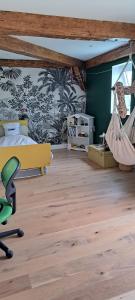 a bedroom with a bed and a hammock at Maison familiale Ecole des Filles in Ully-Saint-Georges +5 photos