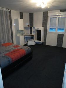 a bedroom with a bed and a tv in it at Bienvenue in Noyers-sur-Cher