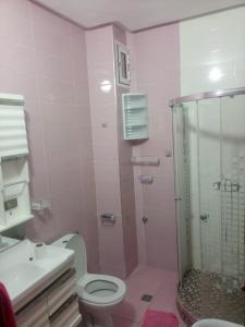 a pink bathroom with a toilet and a shower at aggens immobiler nador in Nador