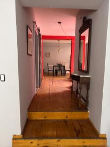 a hallway leading to a dining room with a table at La Plaza in Azul