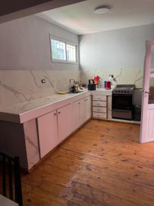 a kitchen with white cabinets and a counter top at La Plaza in Azul