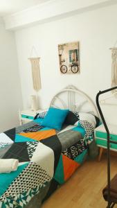 a bedroom with two beds with colorful pillows at Home St Nicolas Home VUT42/000161 in Soria