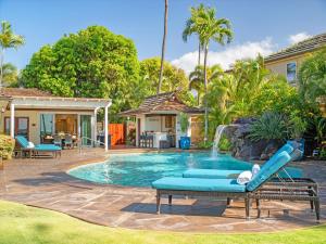 ein Pool mit Rutsche neben einem Haus in der Unterkunft Remodeled Beachfront Estate, Magnificent Mango Surf in Kihei