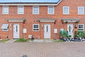 a red brick building with white doors and windows at Black Friday Deal - Stunning 2BR House with Garden, Netflix Walk 30min to Alton Tower in Stoke on Trent