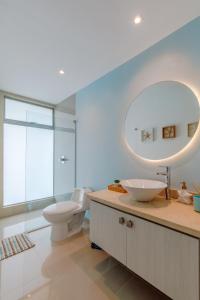 a bathroom with a sink and a toilet and a mirror at Escapada 5 estrellas frente al mar - sonest morros in Cartagena de Indias