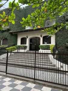 a house with a fence in front of it at Cobertura com jacuzzi na enseada in Guarujá