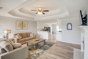 a living room with a couch and a ceiling fan at Patio and Spacious Yard Home in Athens in Harvest