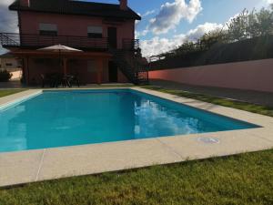 a swimming pool in the yard of a house at Eucalyptus Pink House in Covelo +47 photos