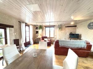 a living room with a couch and a table at La Grange de Montrésor in Montrésor