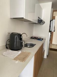 a kitchen with a sink and a toaster on a counter at Apartamento floral in Tunja
