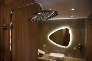 a bathroom with a sink and a mirror at MarieChristine Suites in Mesongi