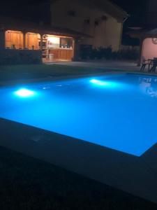 a pool with blue lights in a yard at night at Eucalyptus Pink House in Covelo