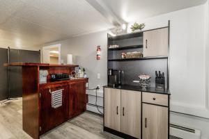 a kitchen with wooden cabinets and a counter at Sweet Blossom Place in Kentville