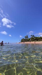 a group of people in the water at a beach at Recanto Ebenézer in Taipu +22 photos